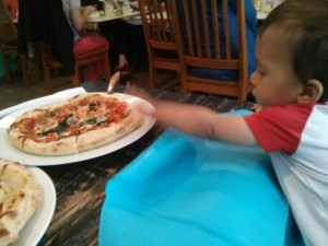 baby eating pizza