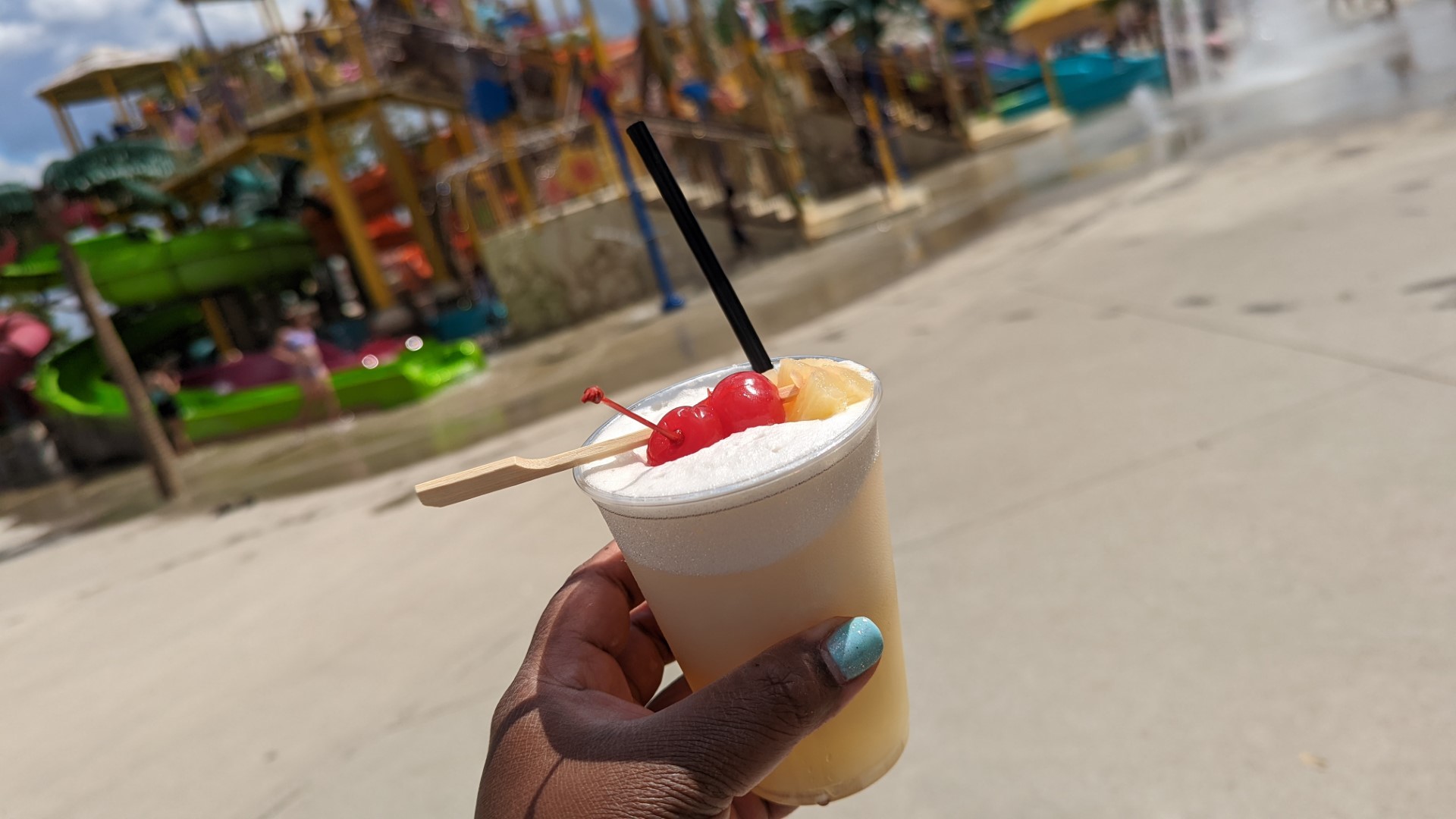 hand holding pina colada at wet n wild