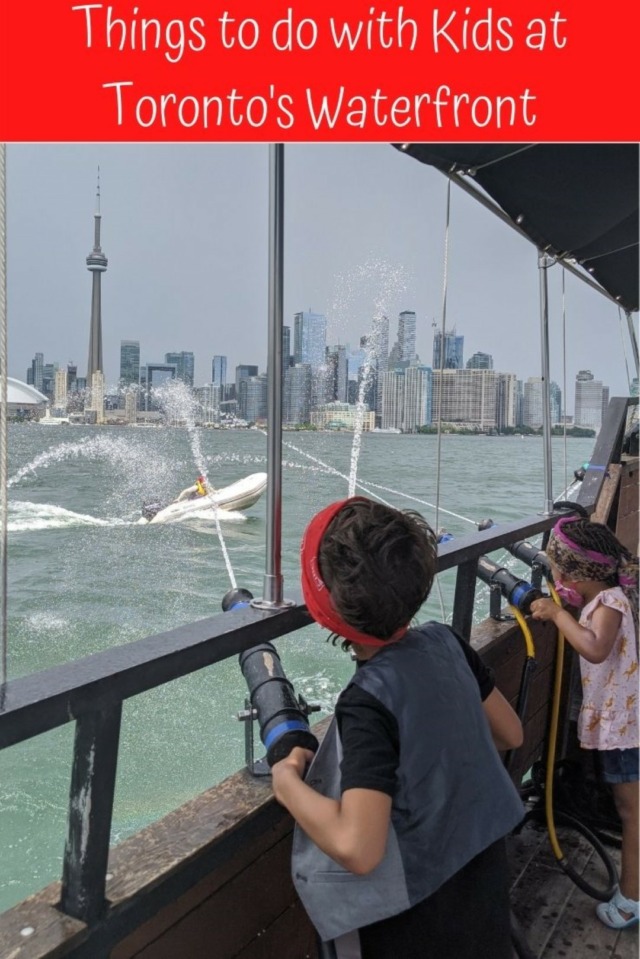 kids splashing pirate in water with cn tower