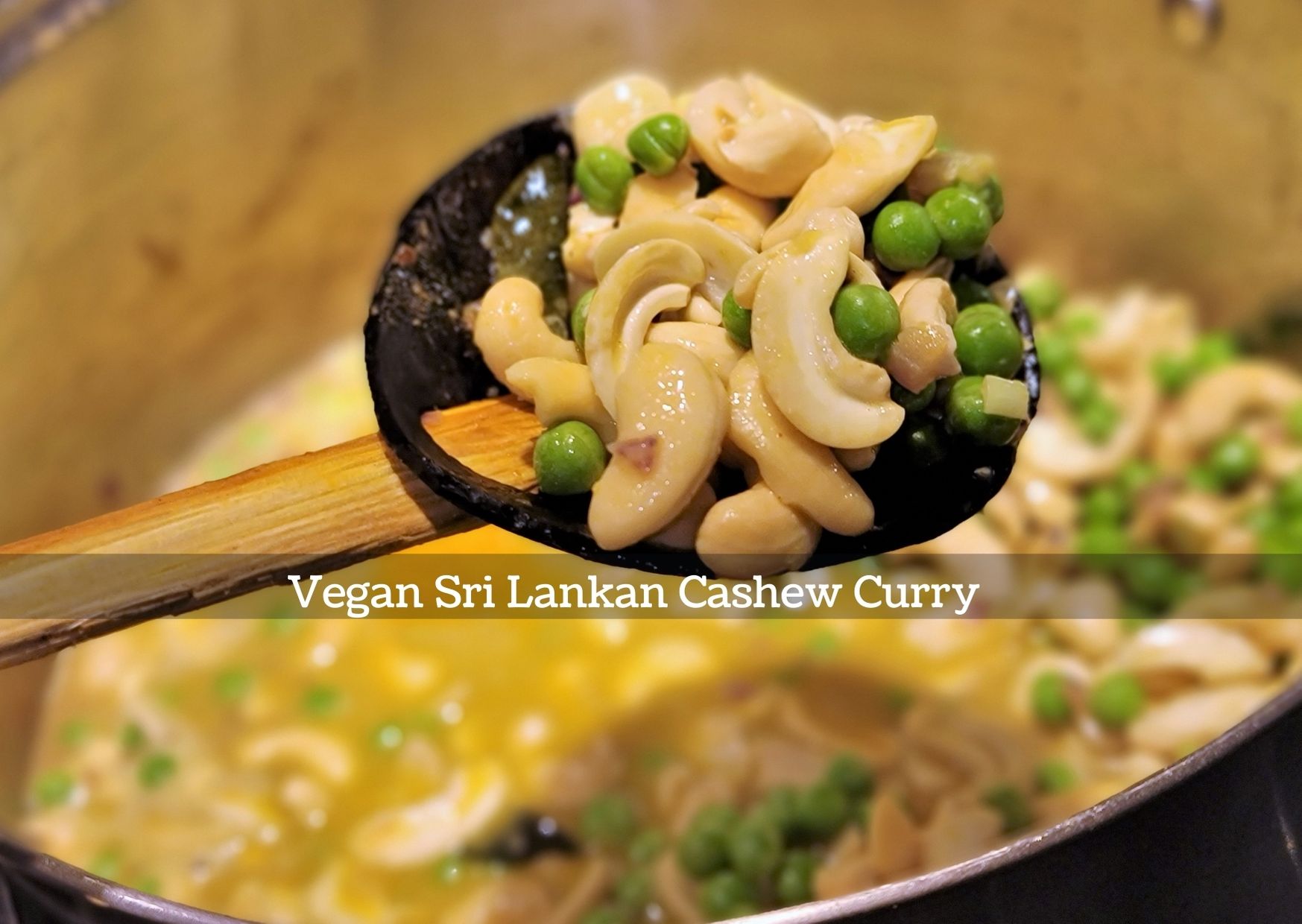 Sri Lankan Cashew Curry with peas on wooden spoon
