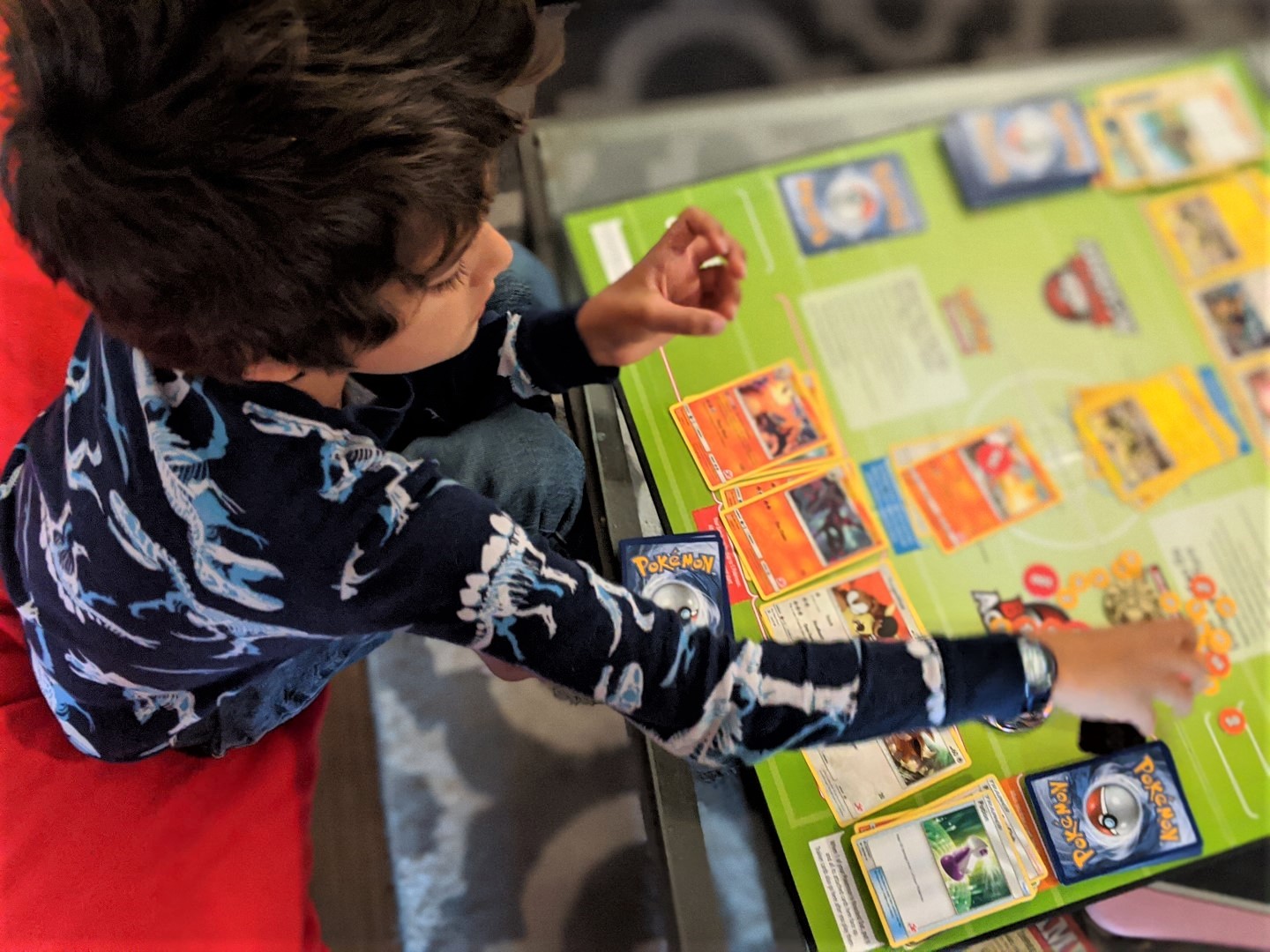 boy playing Pokemon Battle Academy board game for kids