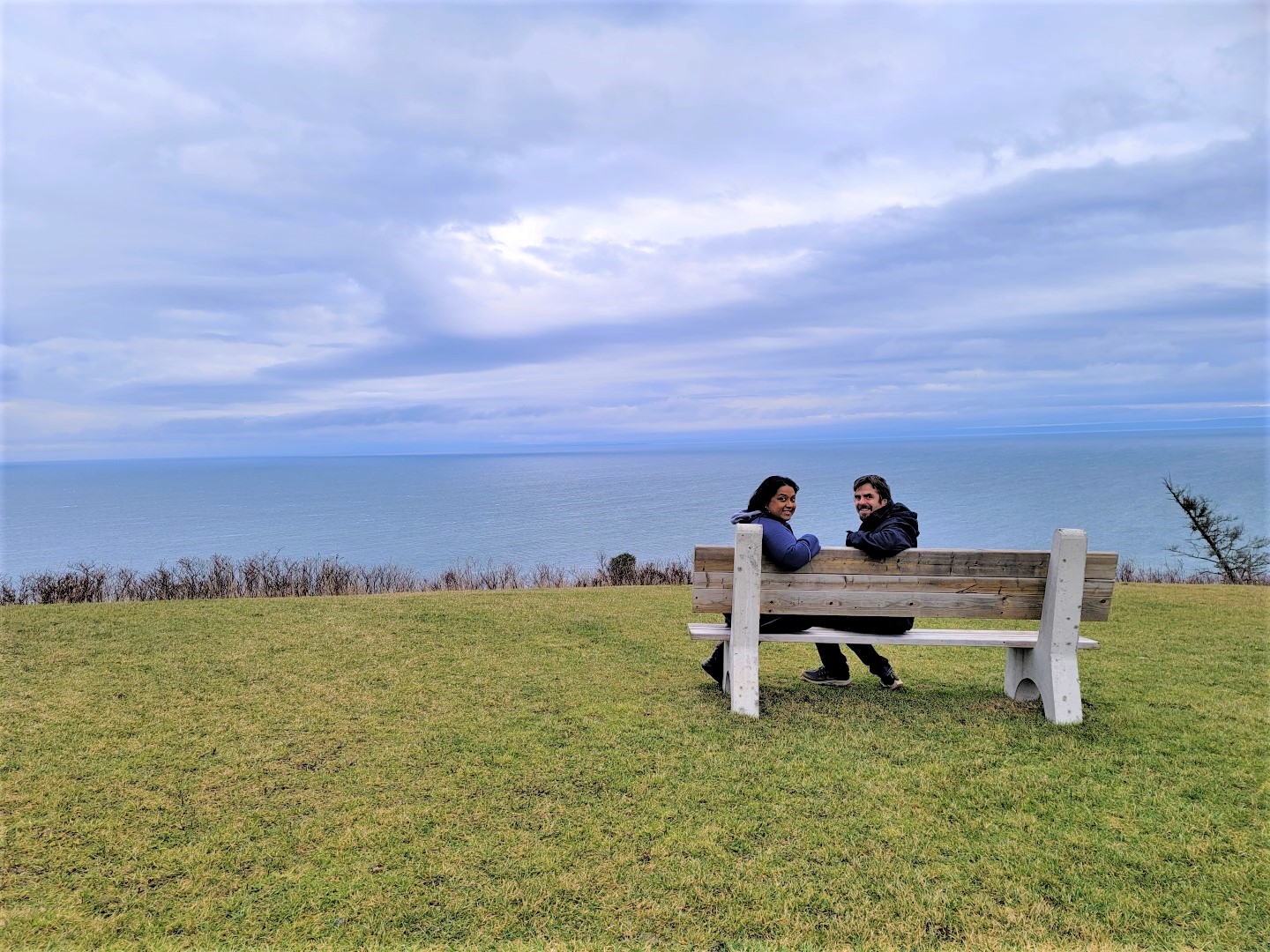 couple sitting on bench at George's Bay