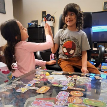 kids high five after board game
