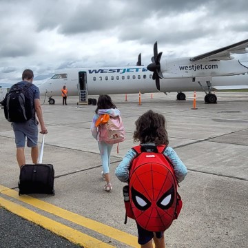 family walking to plane in Sydney Nova Scotia