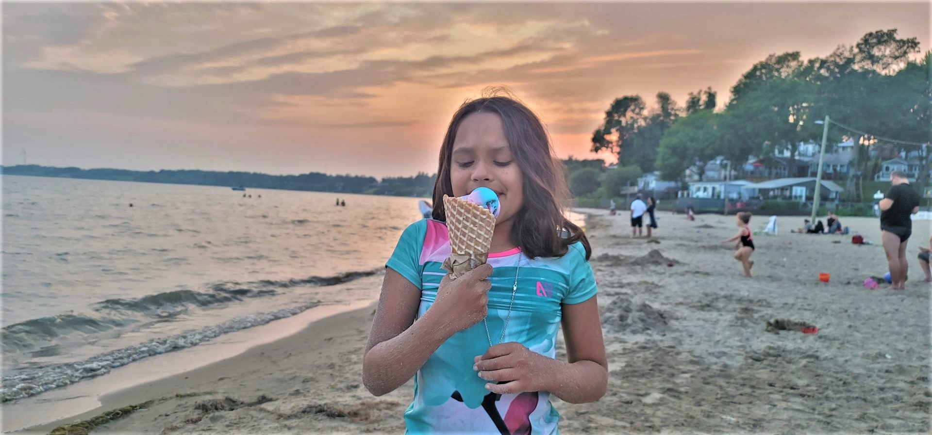 girl eating ice cream at beach