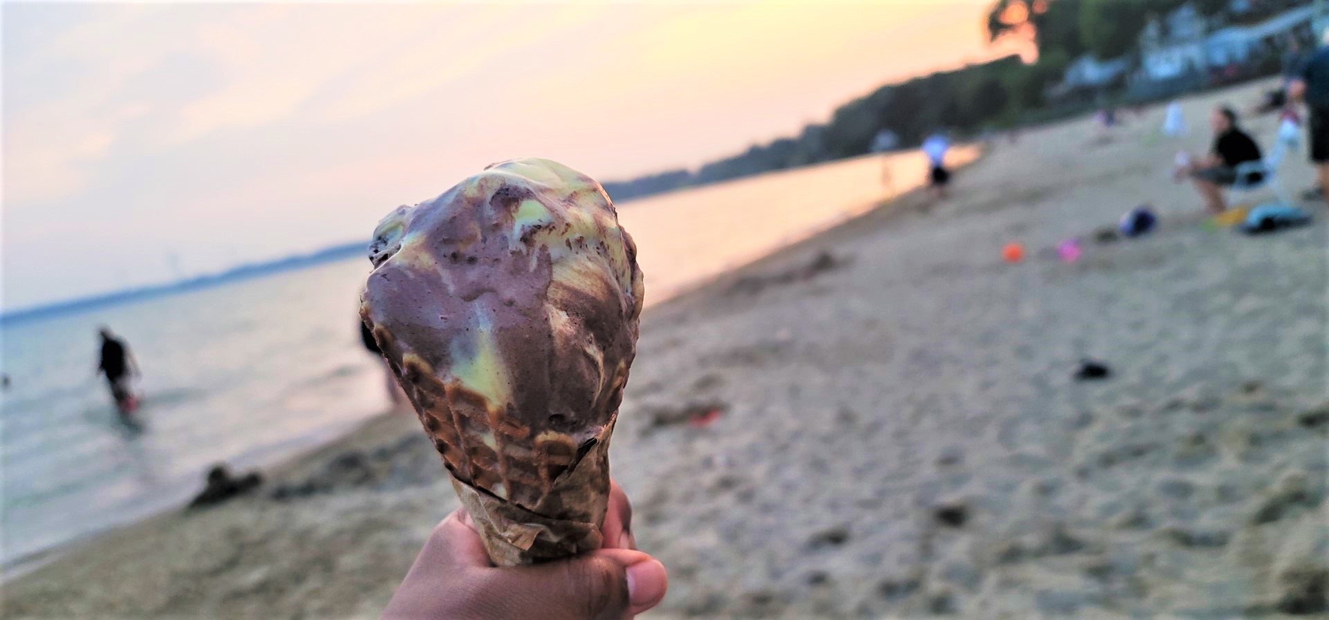 ice cream cone in hand at Port Dover beach at sunset