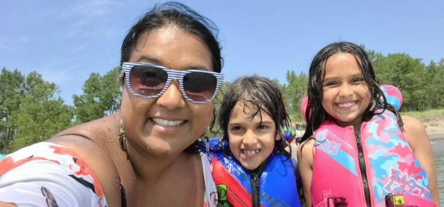 mother and kids smiling at beach