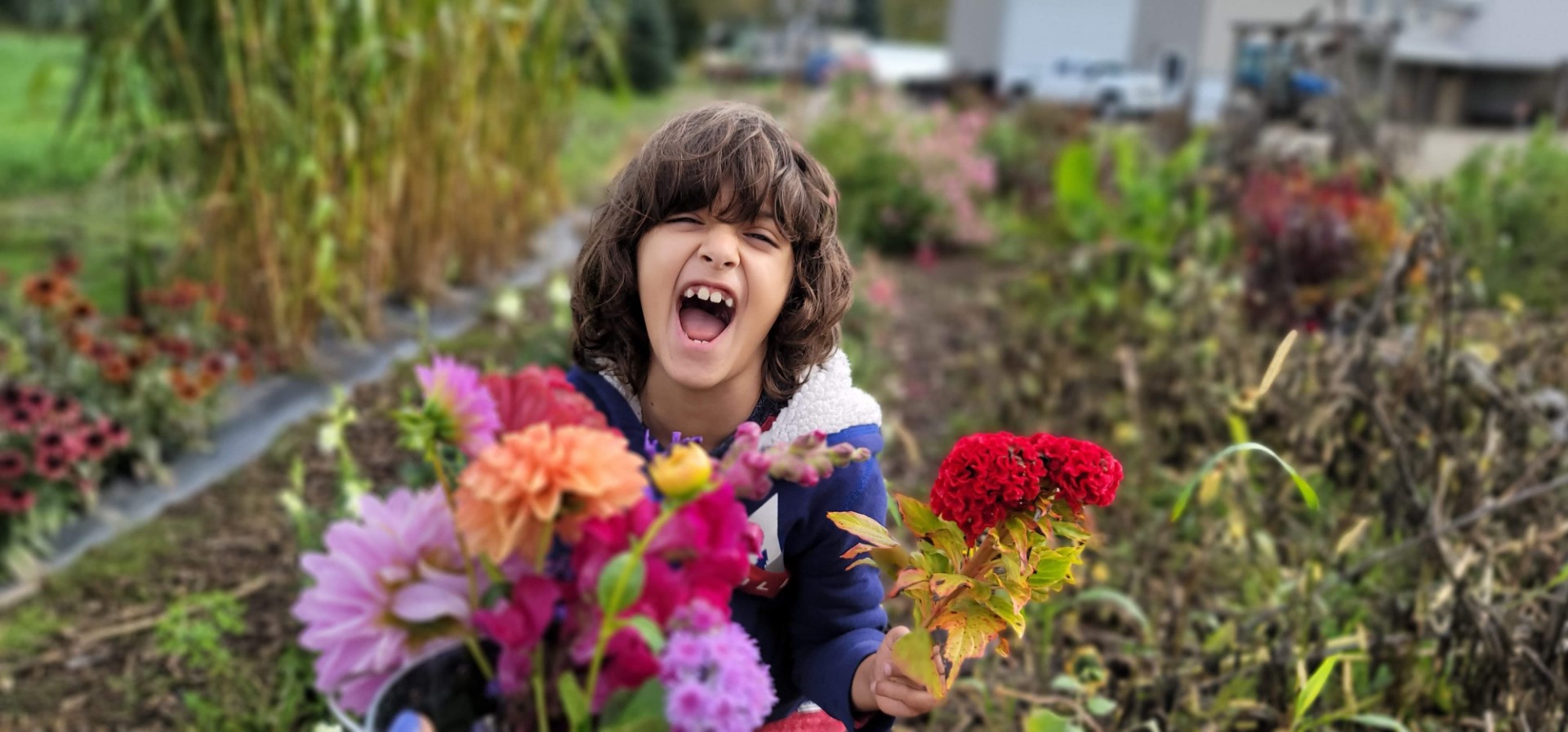 kid smiling at flower bouquet