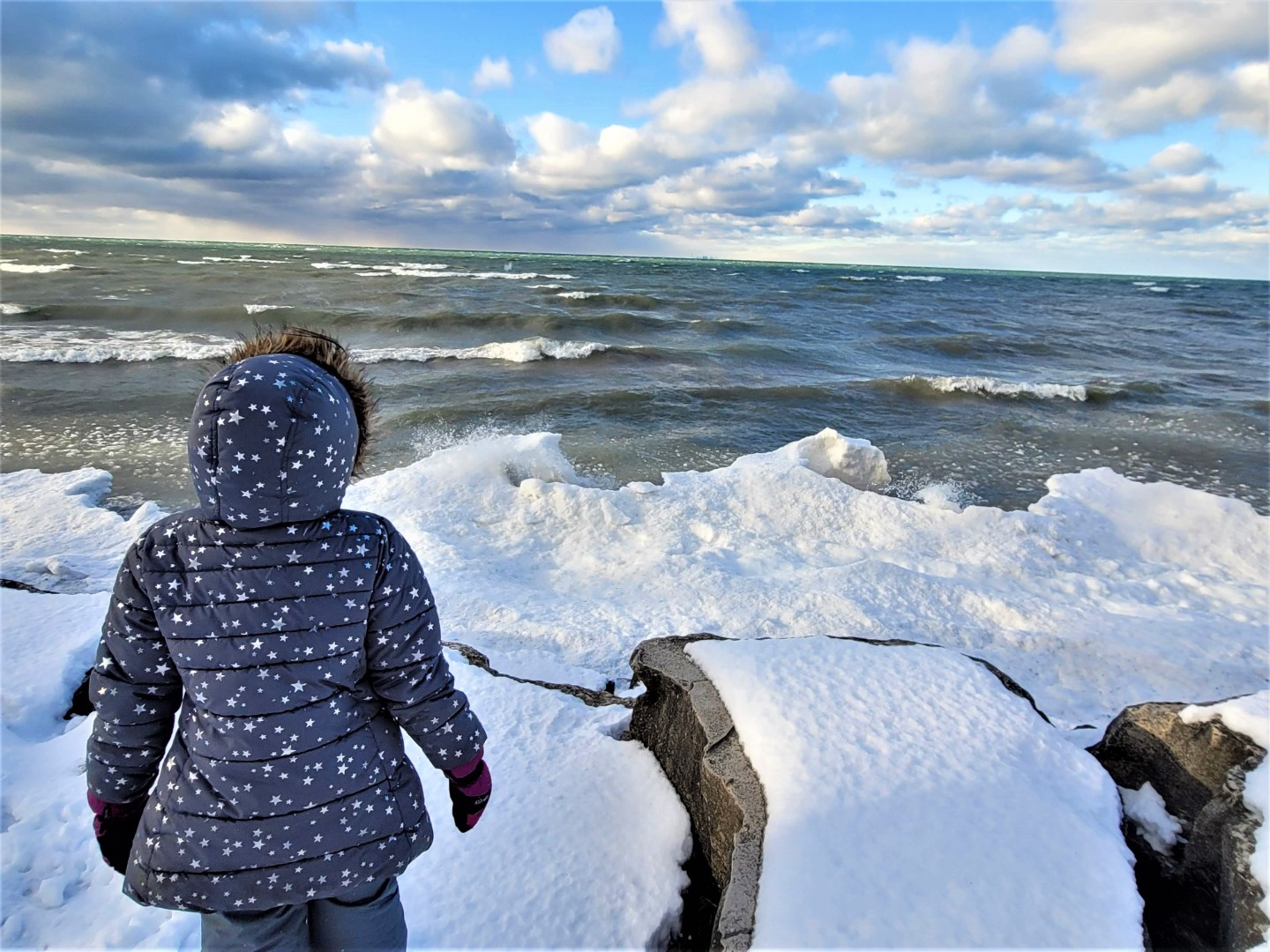 girl standing at niagara on the Lake frozen beach