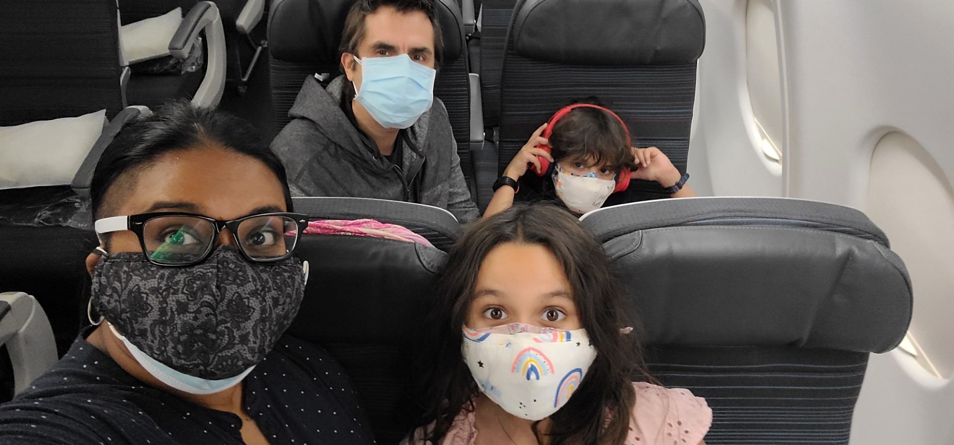 Masked family on airplane