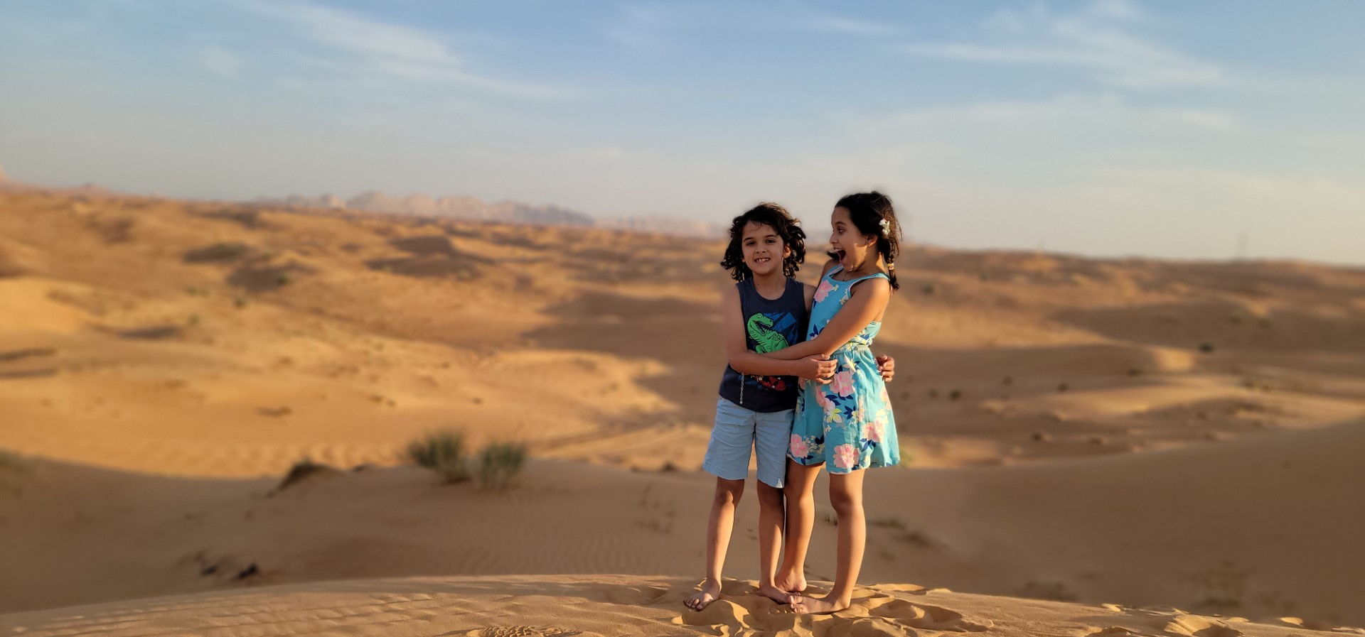 siblings hugging each other in the Arabian desert 