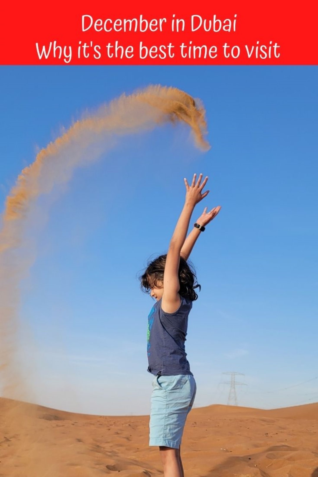 kid throwing sand in air Dubai in December 