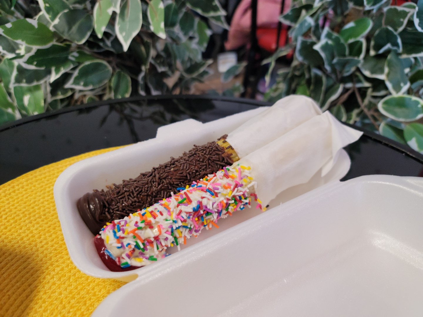 brightly decorated Churros in a white container