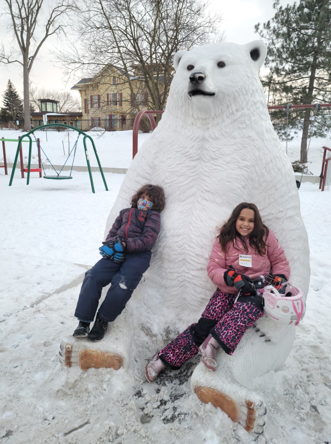 kids sitting on polar bear at gage park playground