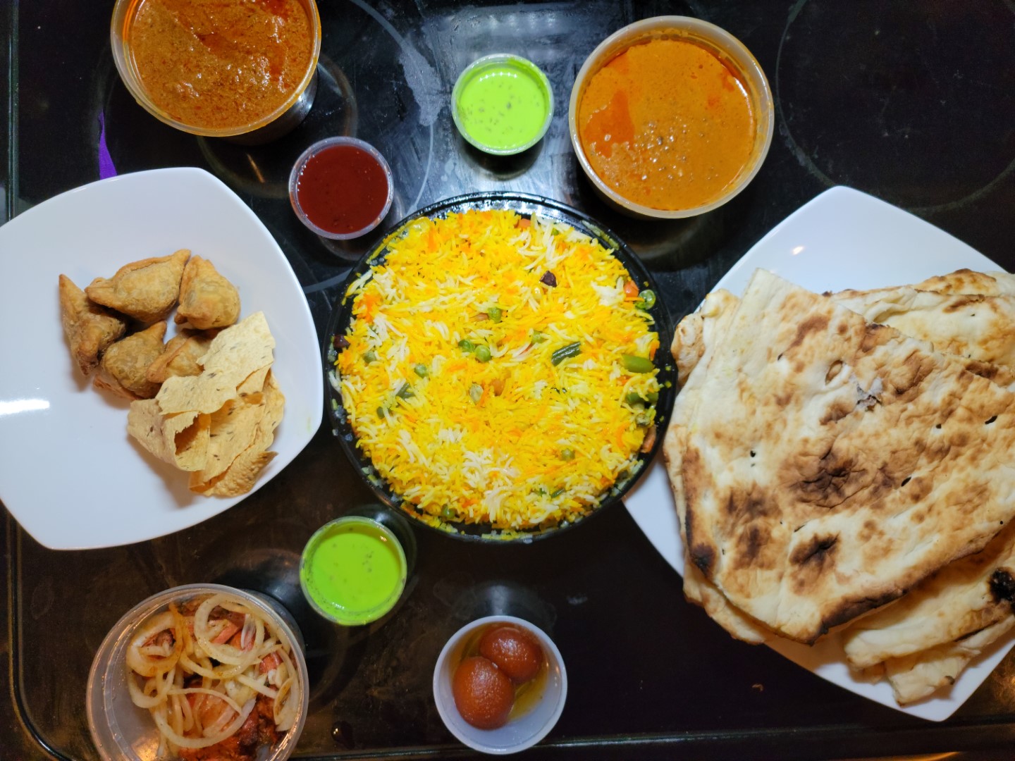 indian food on table with biriyani and curry