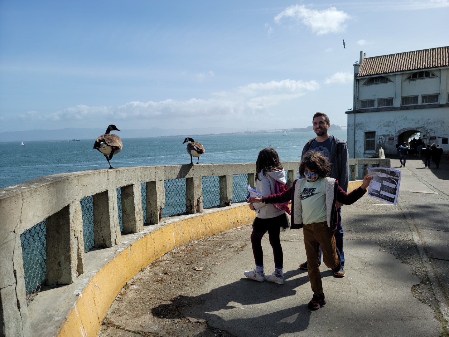 family standing next to birds on Alcatraz island