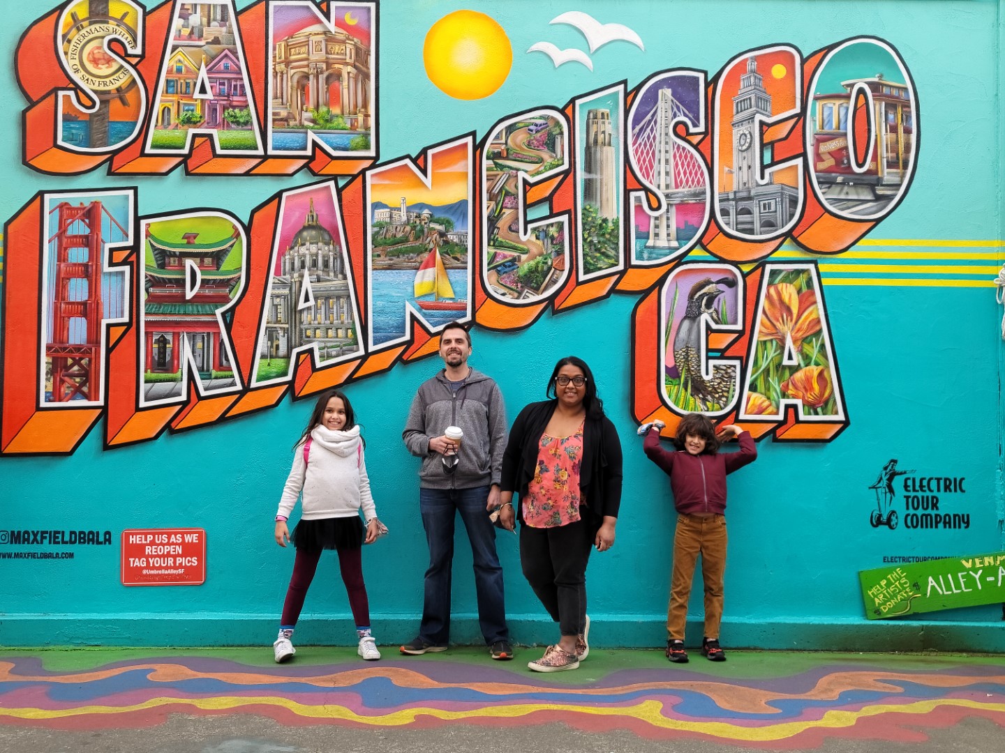 family standing in front of San Francisco sign
