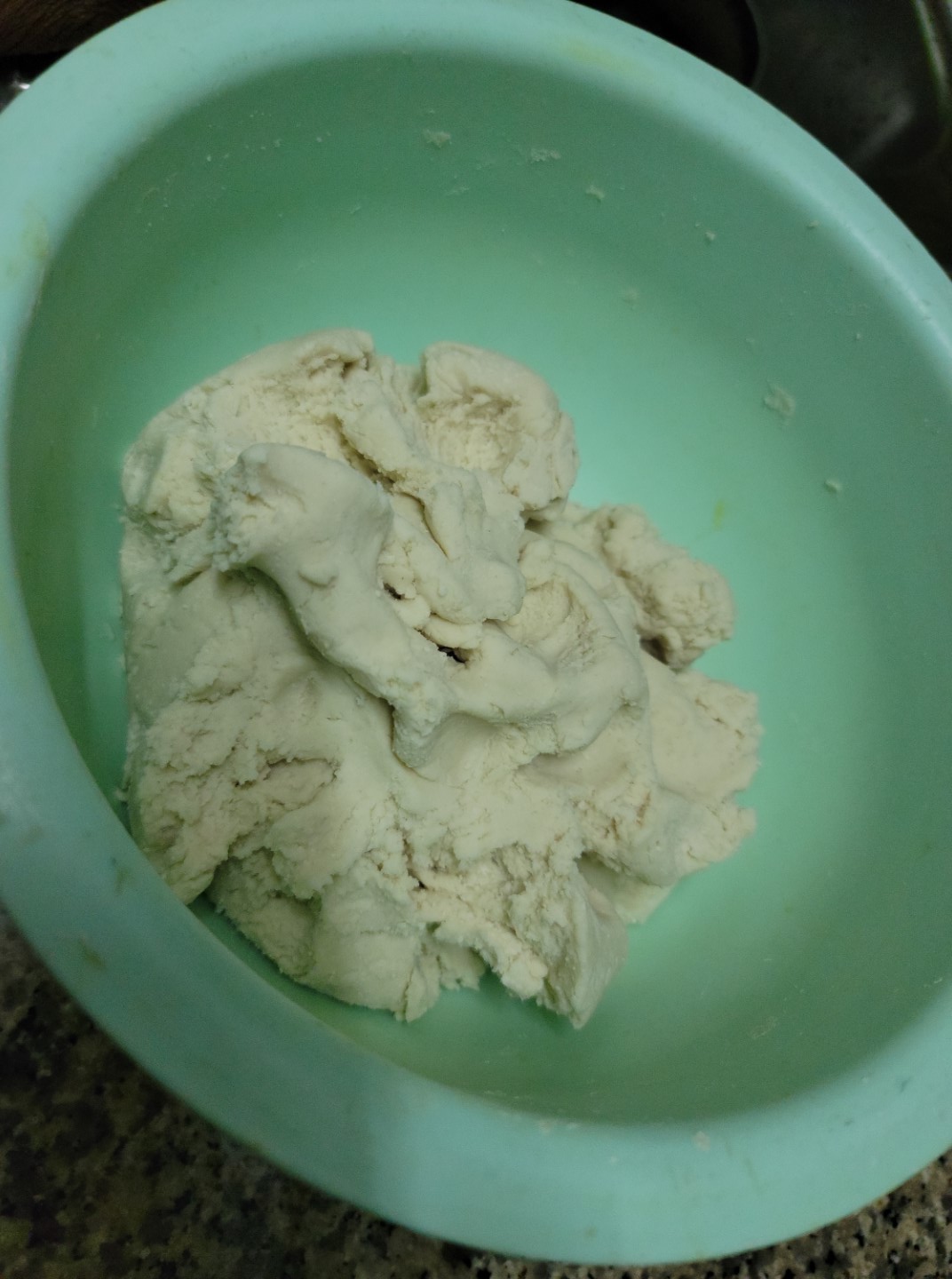 mani pittu dough in green bowl