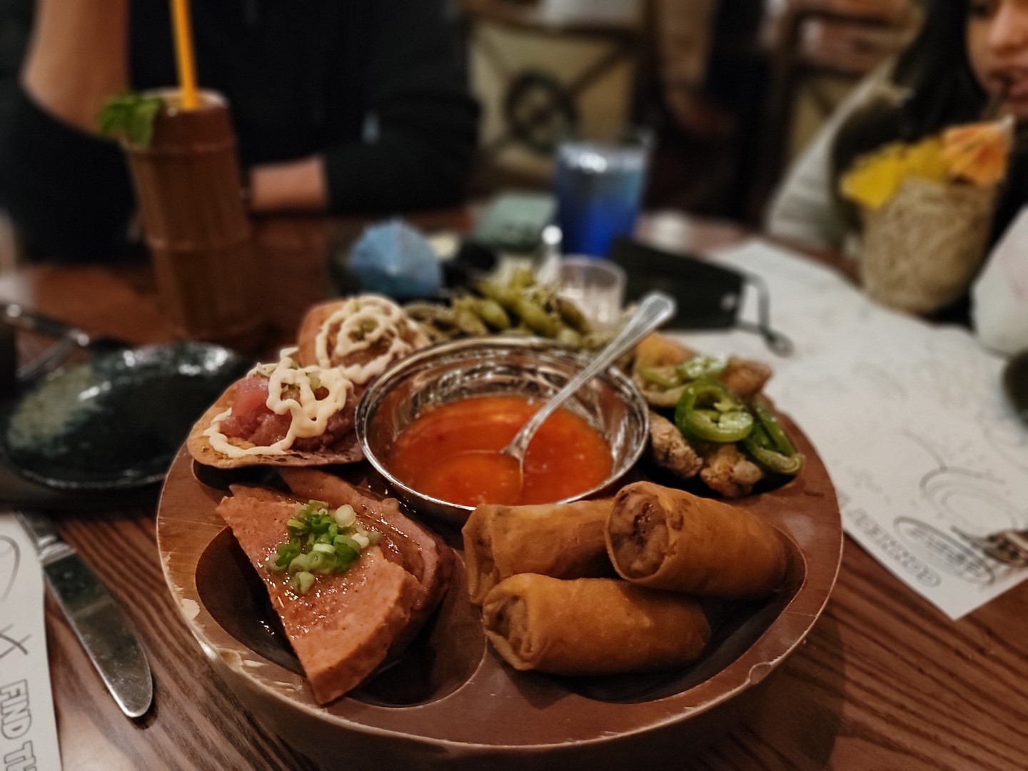 food tray with spring rolls and fried spam with sauce