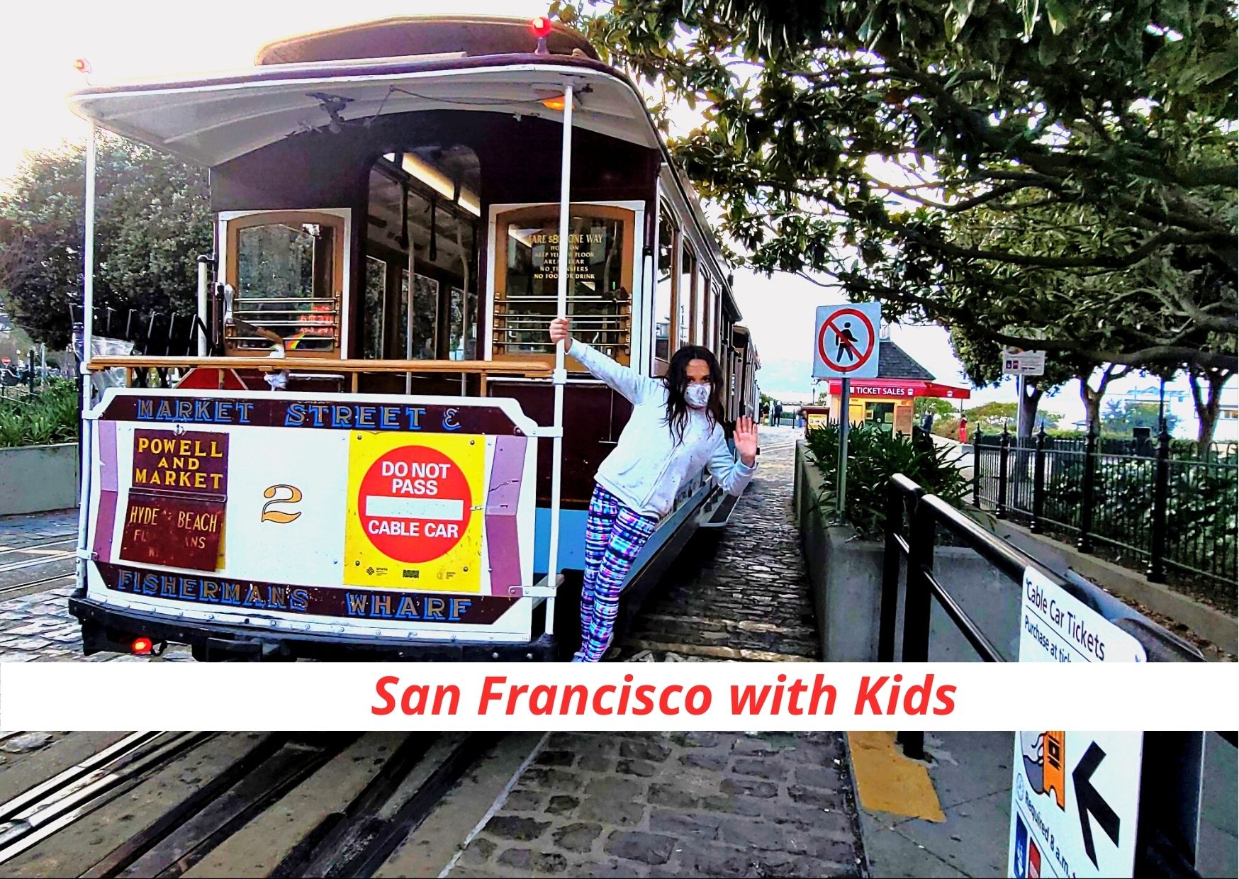 child leaning on San Francisco cable car