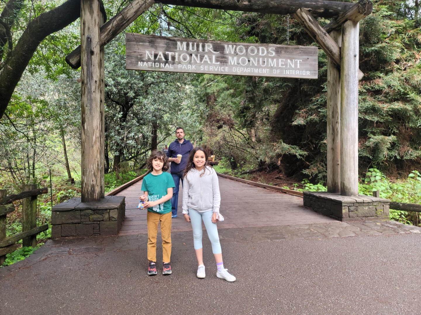 kids standing in front of muir woods sign