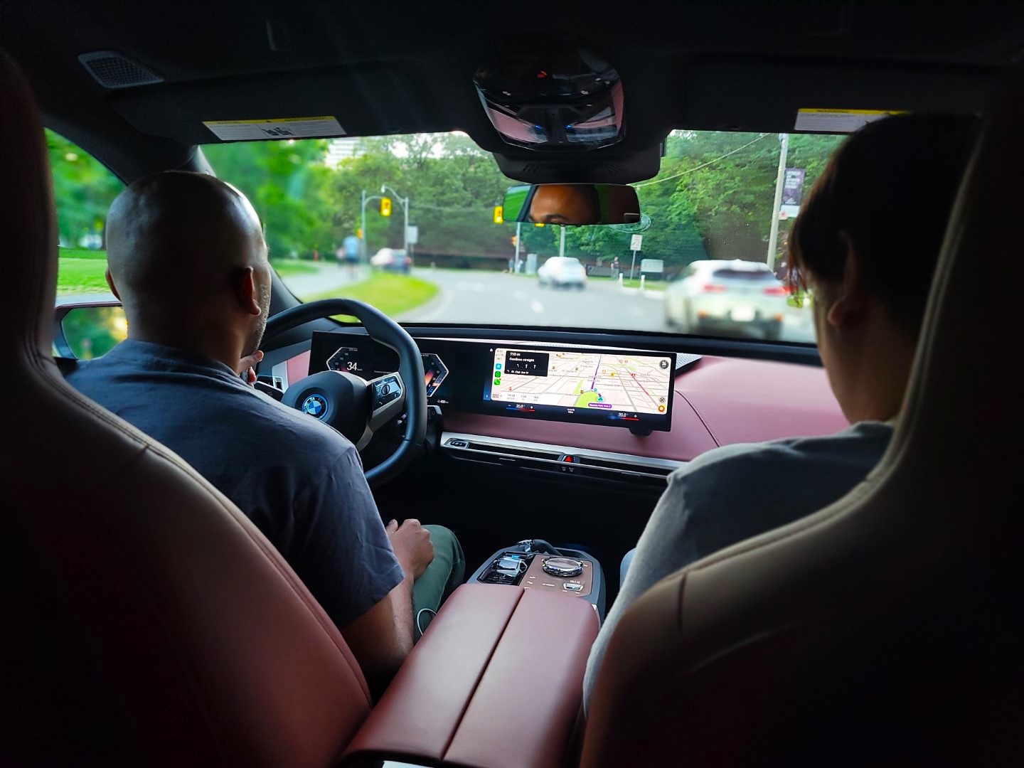 bald man driving the electric BMW iX