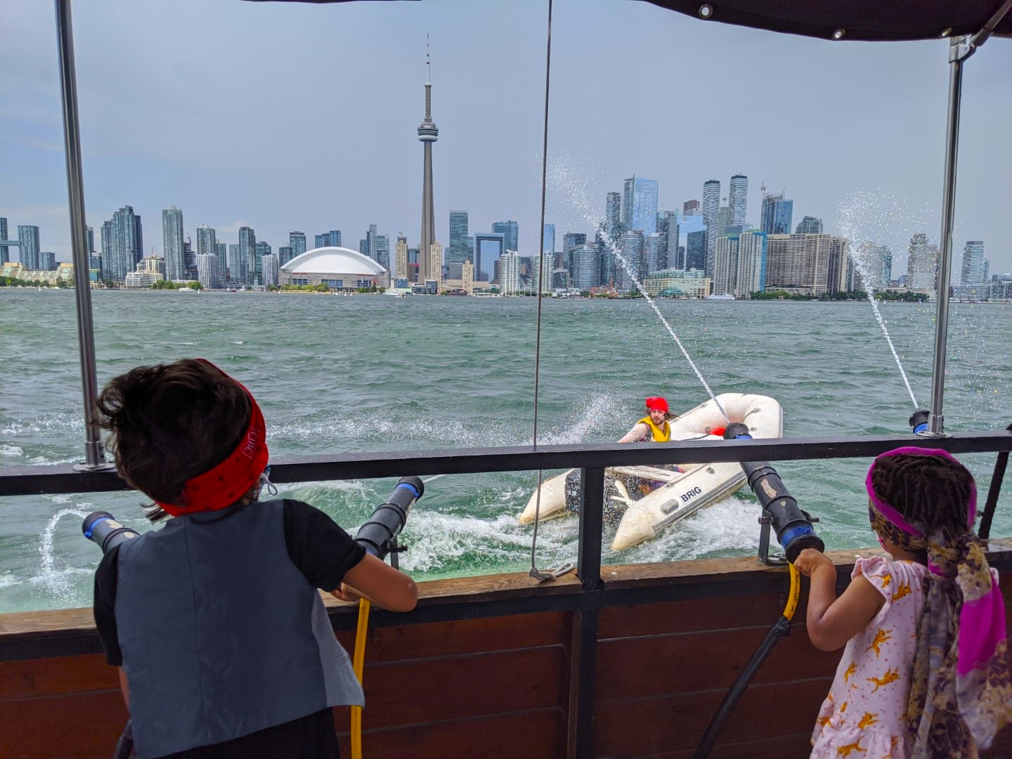 kids shooting pirate on boat in front of cn tower