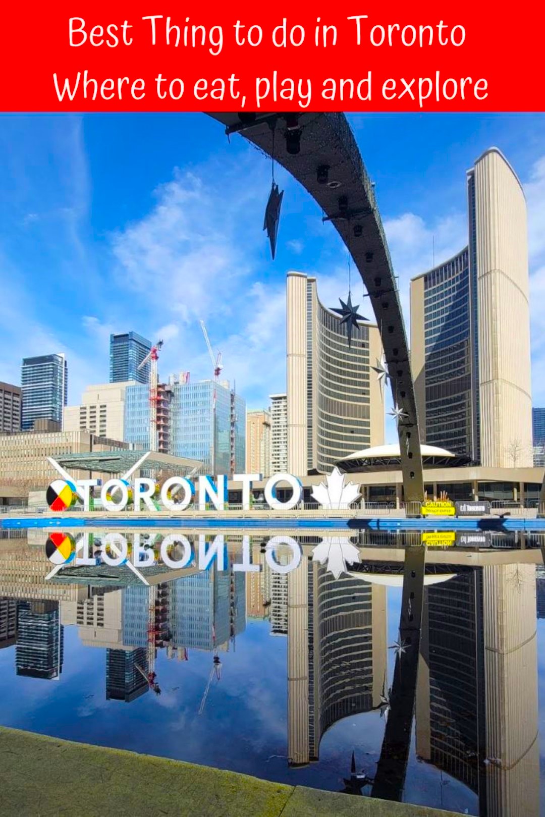 Toronto sign with reflections of building