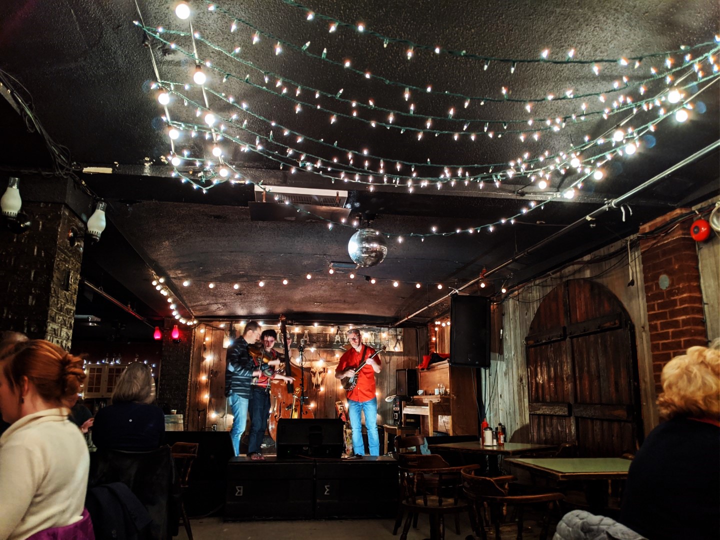 band performing on stage under lights at Dakota tavern
