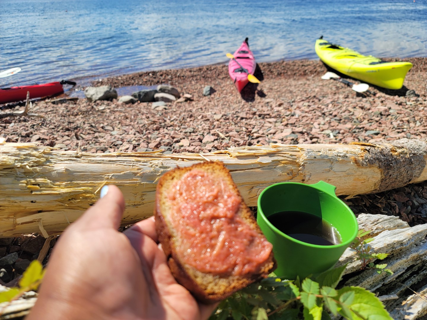 bread and jam at beach with kayaks