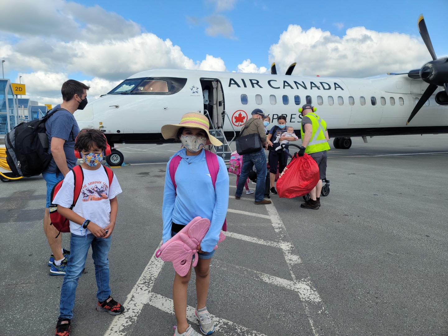 Family at Nova Scotia airport with air canada plane in background