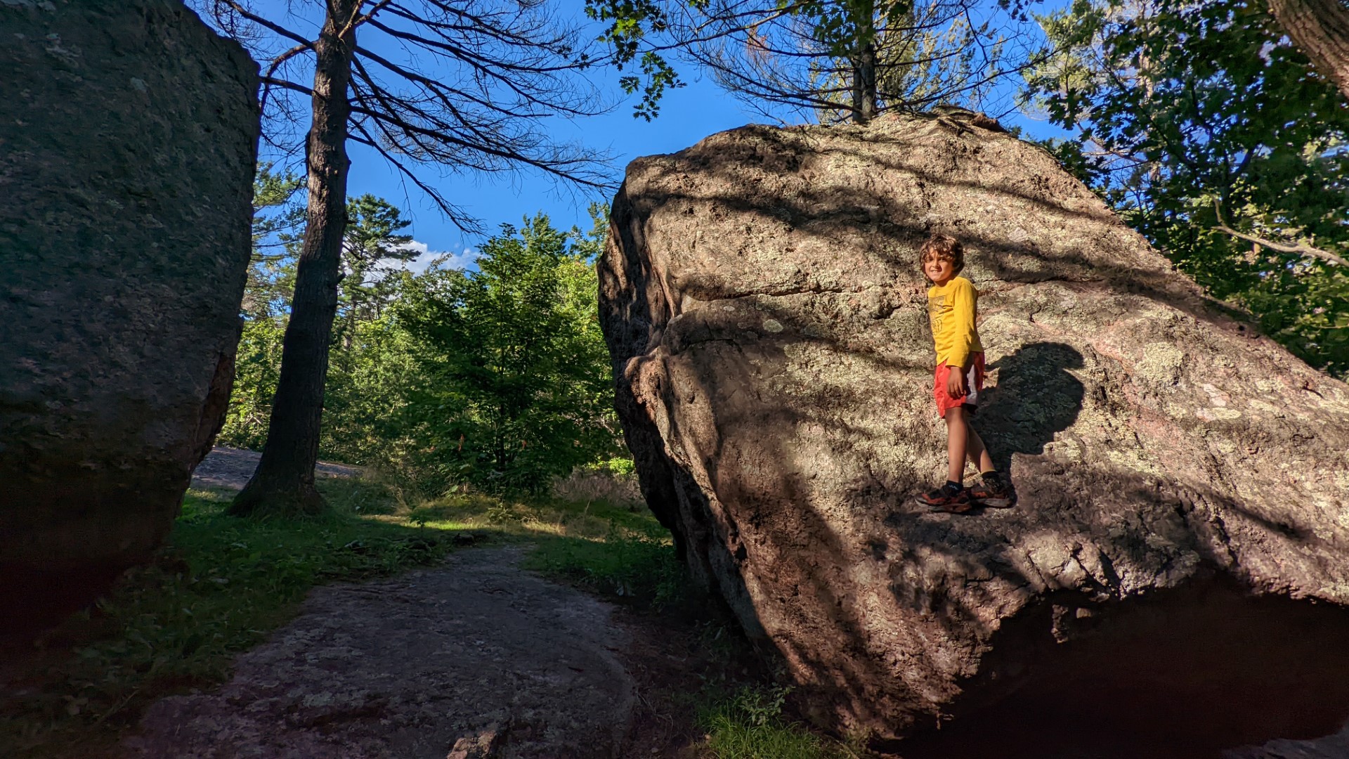 boy standing at Adam and Eve Rock in Ontario