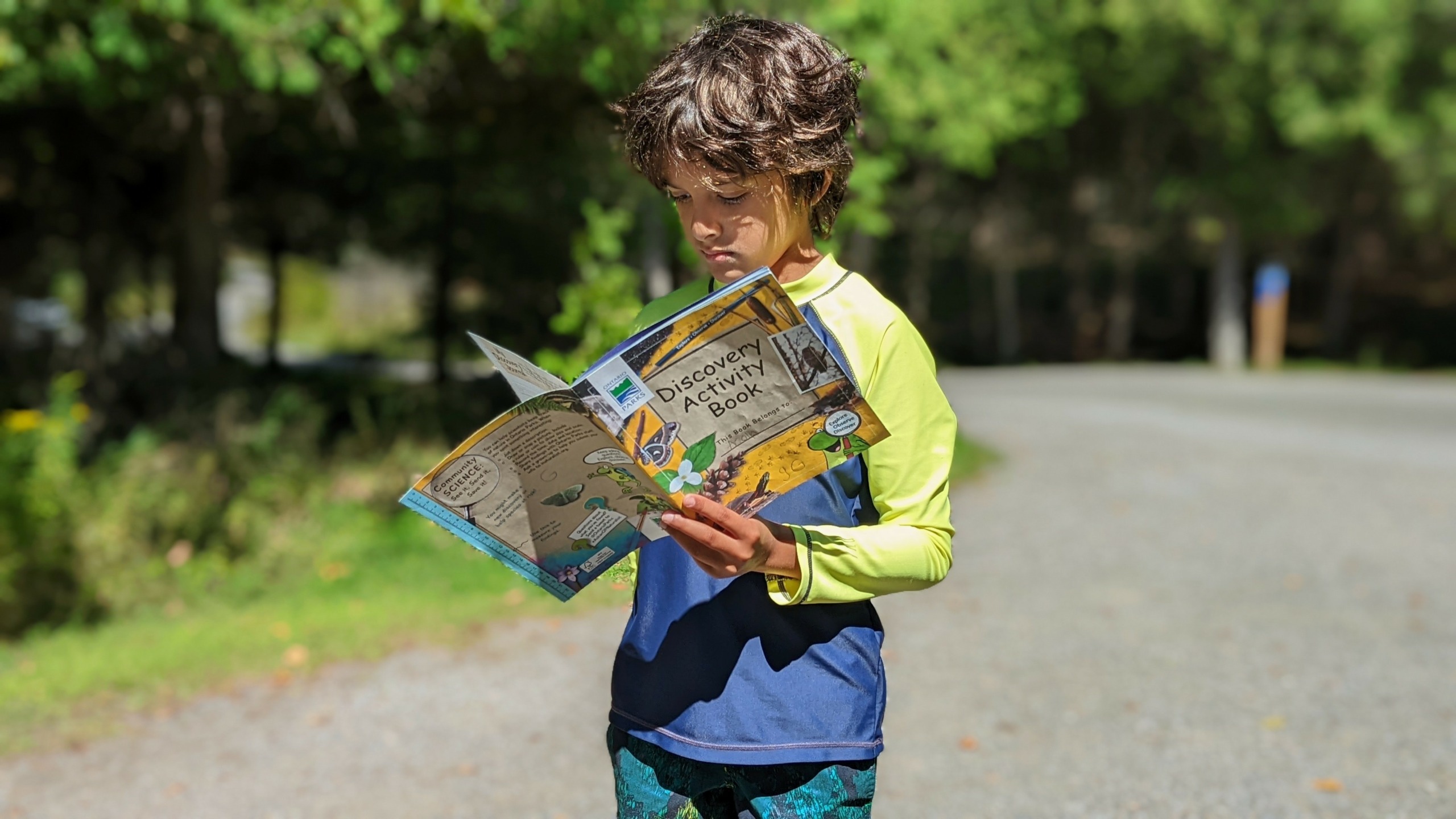 boy holding Ontario PArks discovery book