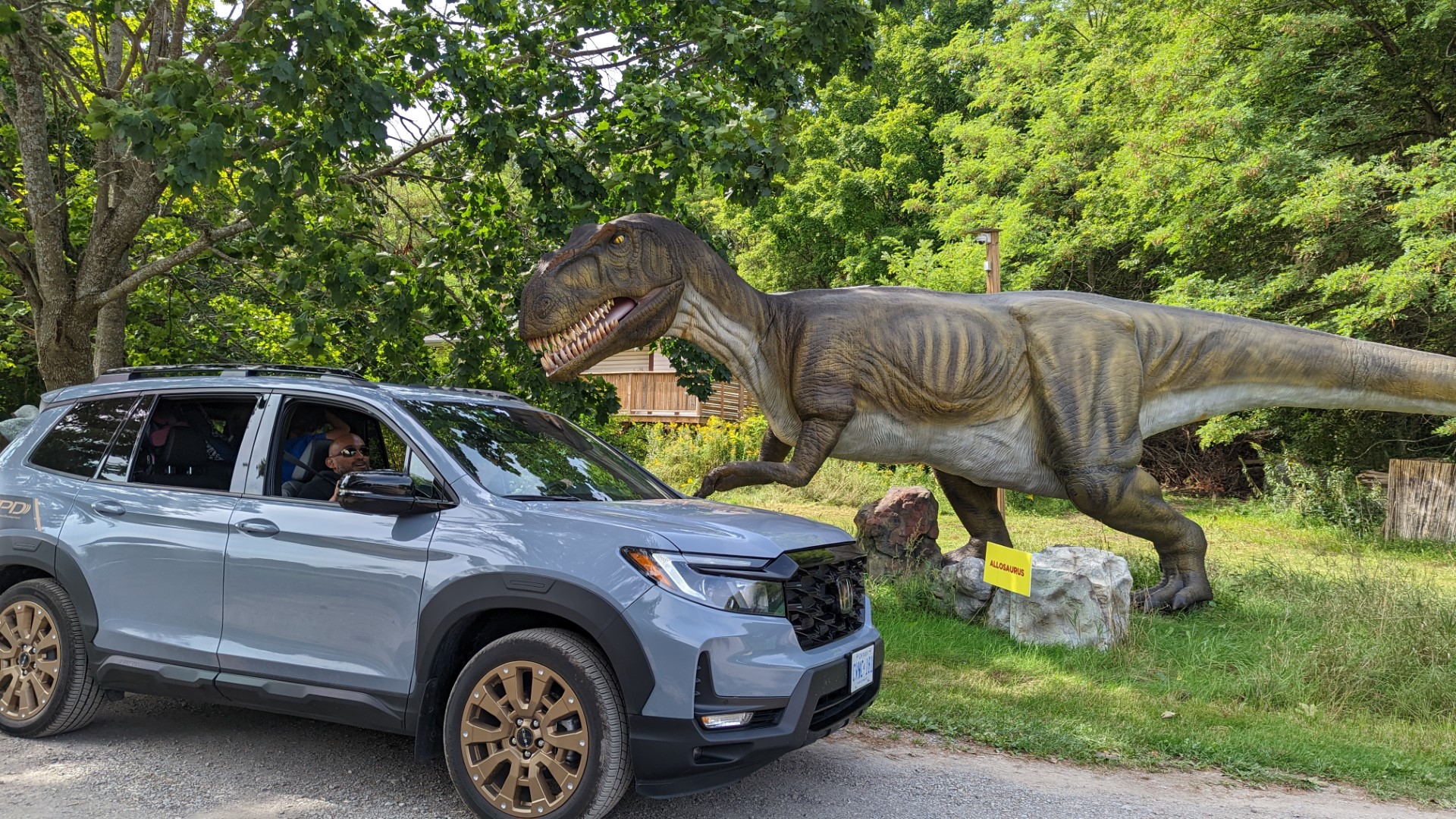 Dinosaur in Ontario next to Honda Passport Touring