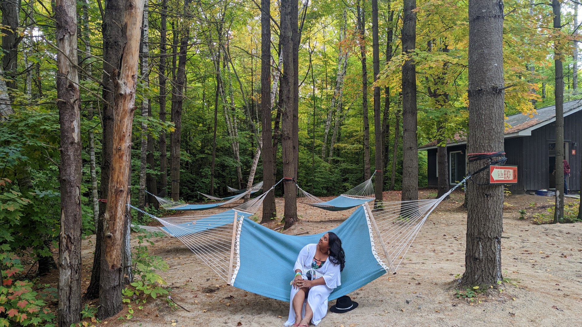 Lady in white sitting on hammock in Muskoka woods