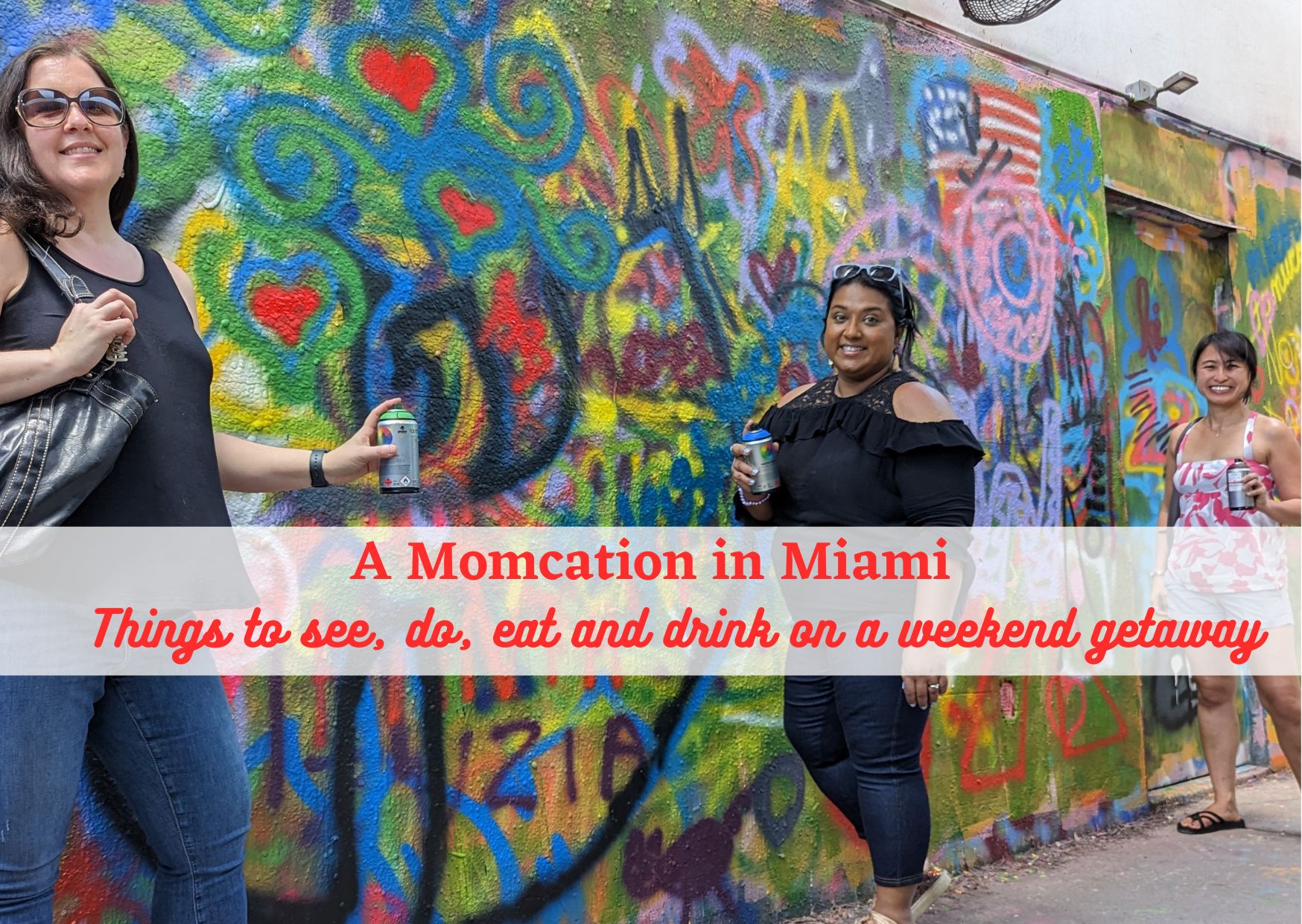 girls standing in front of Wynwood Walls Mural with spray paint cans in Miami