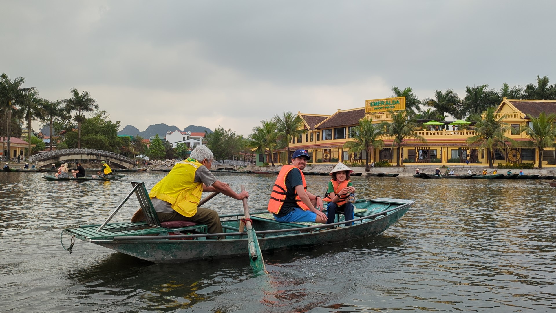 Father and son being rowed in Tam coc village