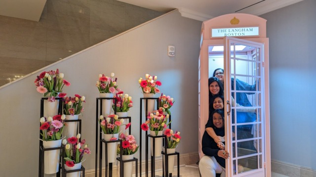 girls in a langham hotel pink phonebooth