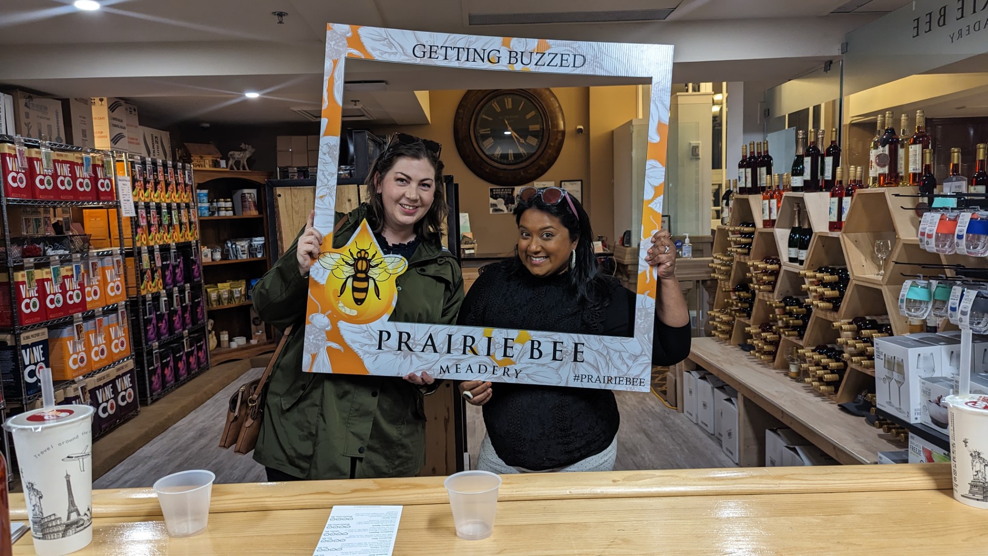 Yashy and friend holding Prairie Bee Sign