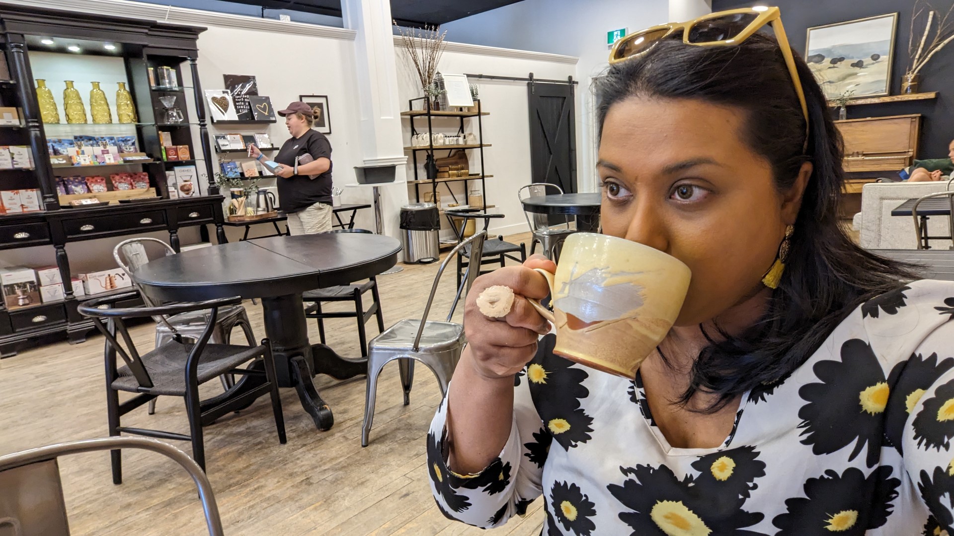 South Asian Canadian Travel Writer Yashy sipping coffee in Moose Jaw