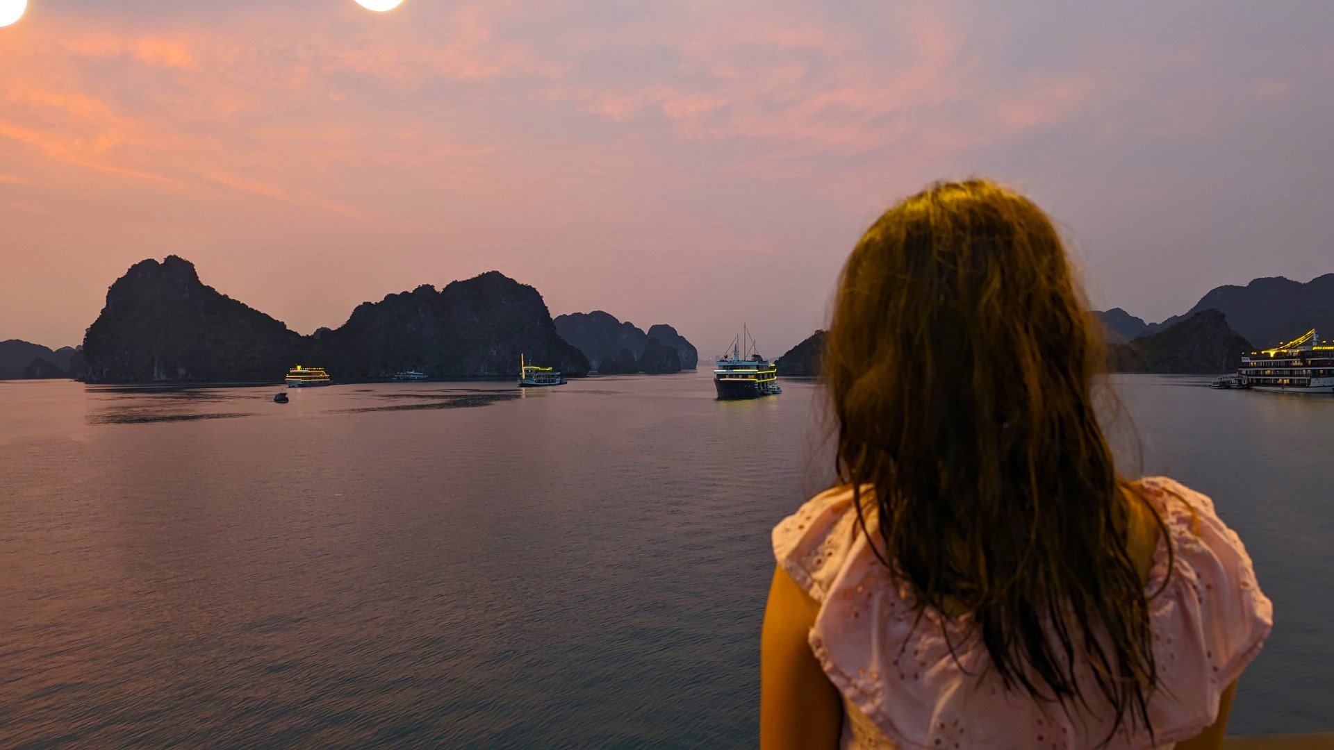 girl looking at ha long bay at sunset