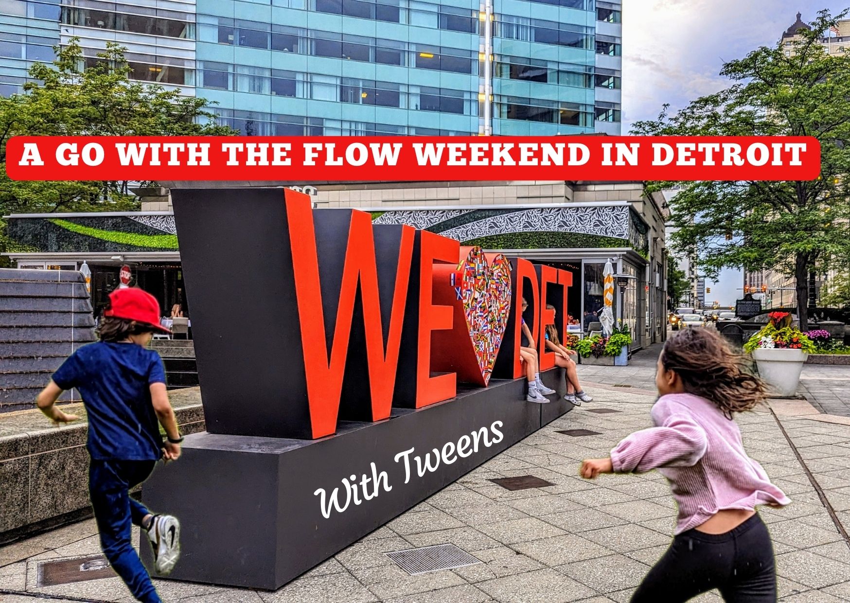 Children running at We love Detroit sign