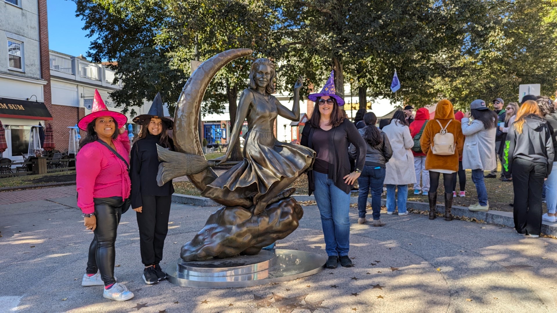 girls in front of Bewitched statue in Salem