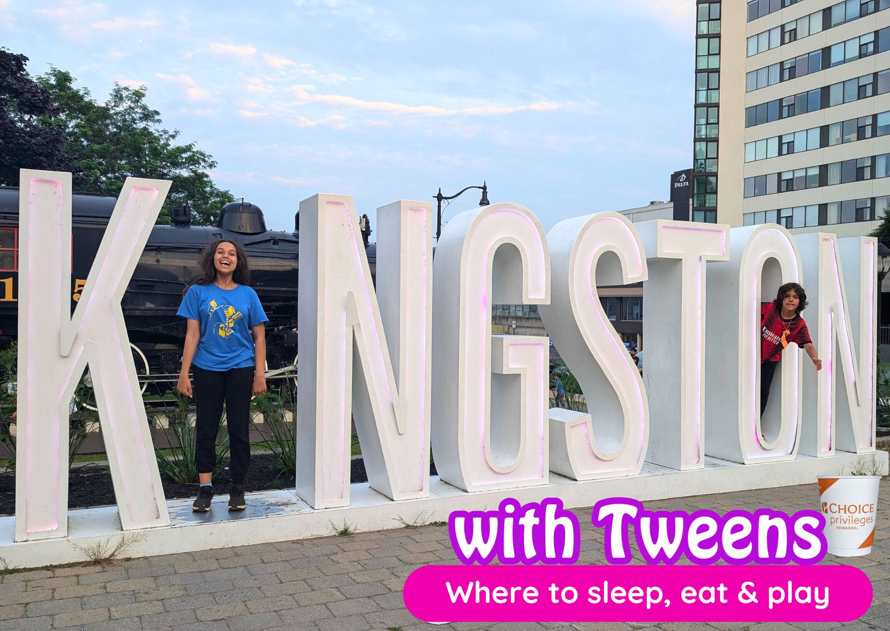 kids standing in Kingston sign