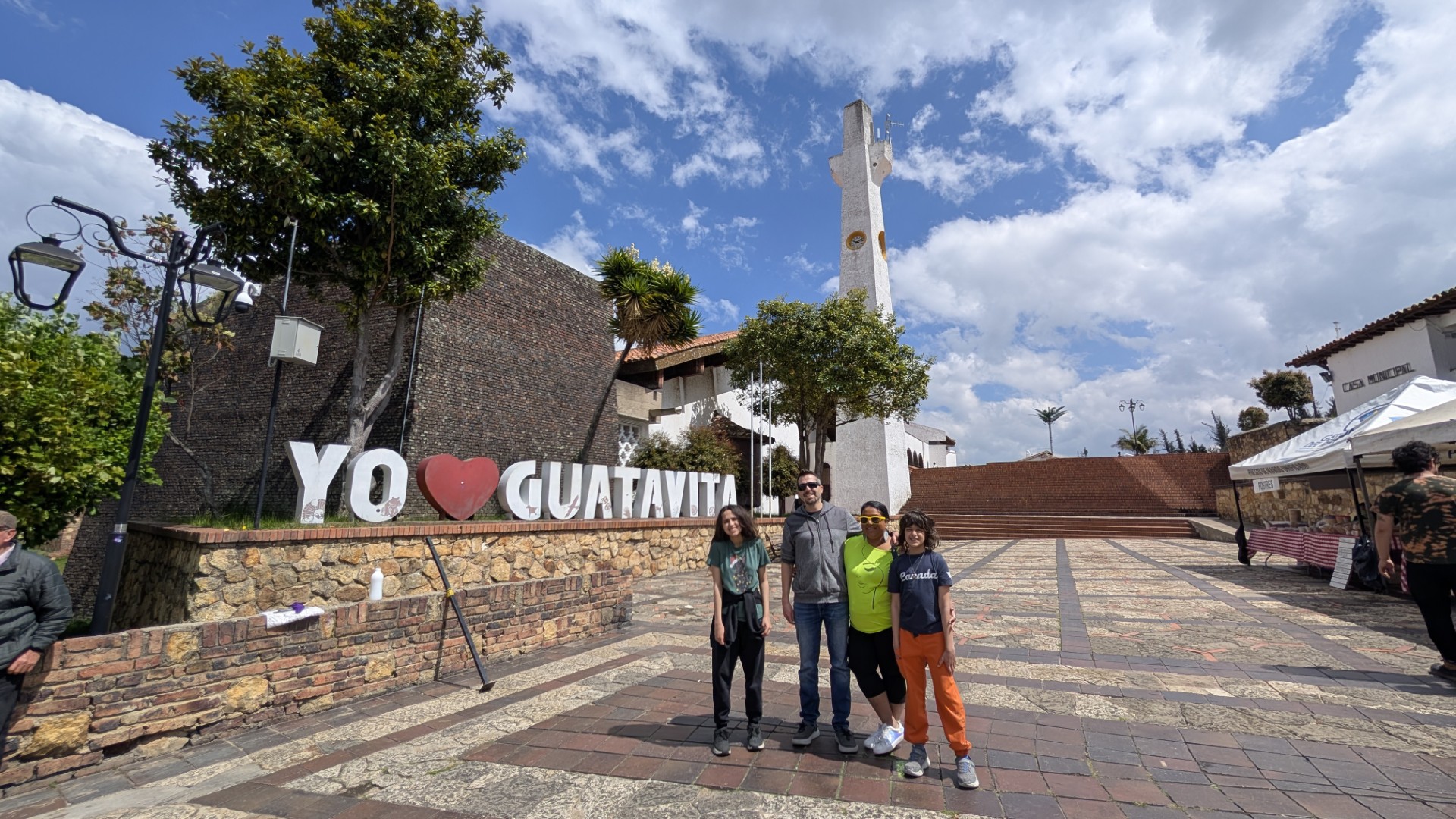 family in front of yo guatavita sign