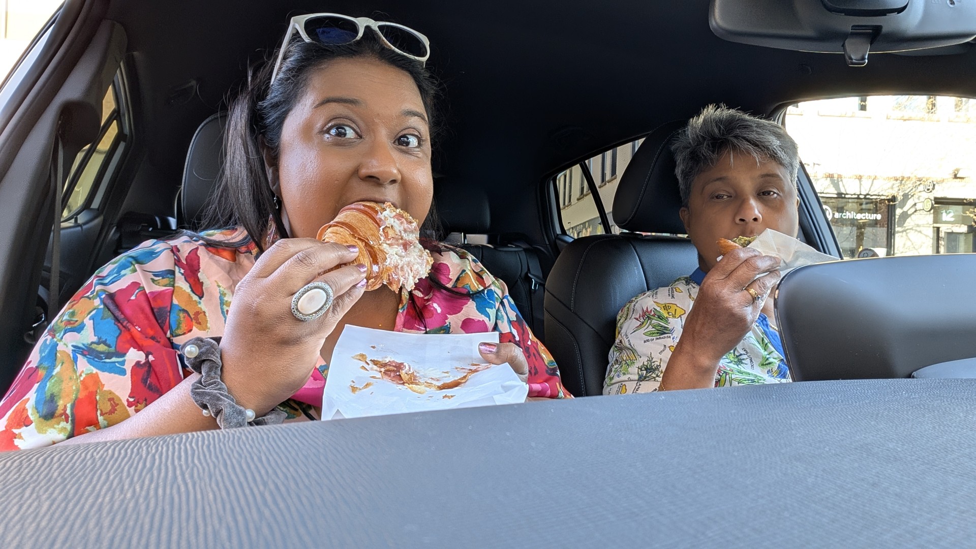 ladies eating baked goods in car