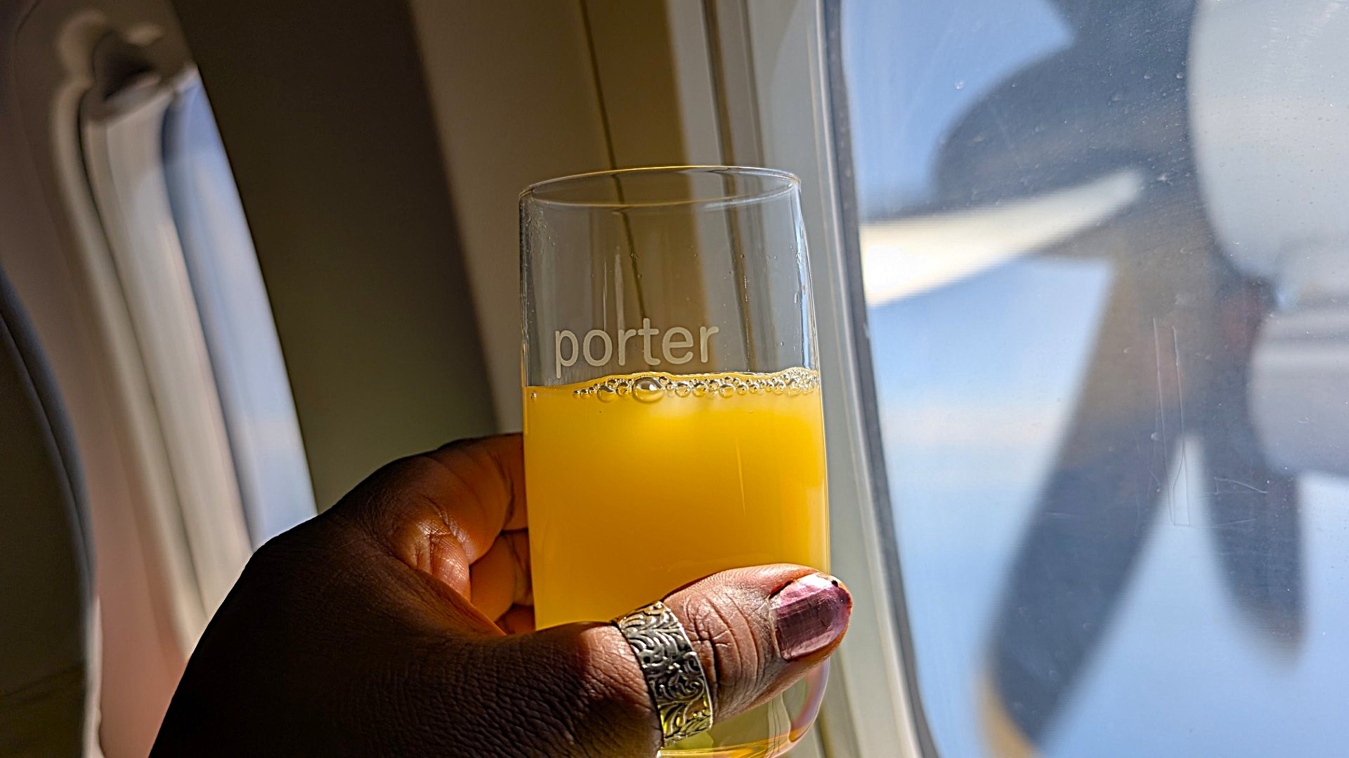 GLASS IN HAND ON PORTER AIRLINES