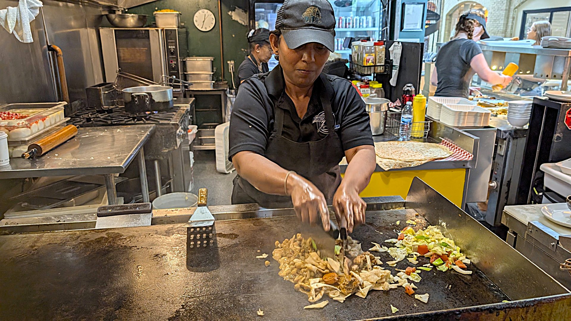 lady making Sri Lankan food in Winnipeg food hall