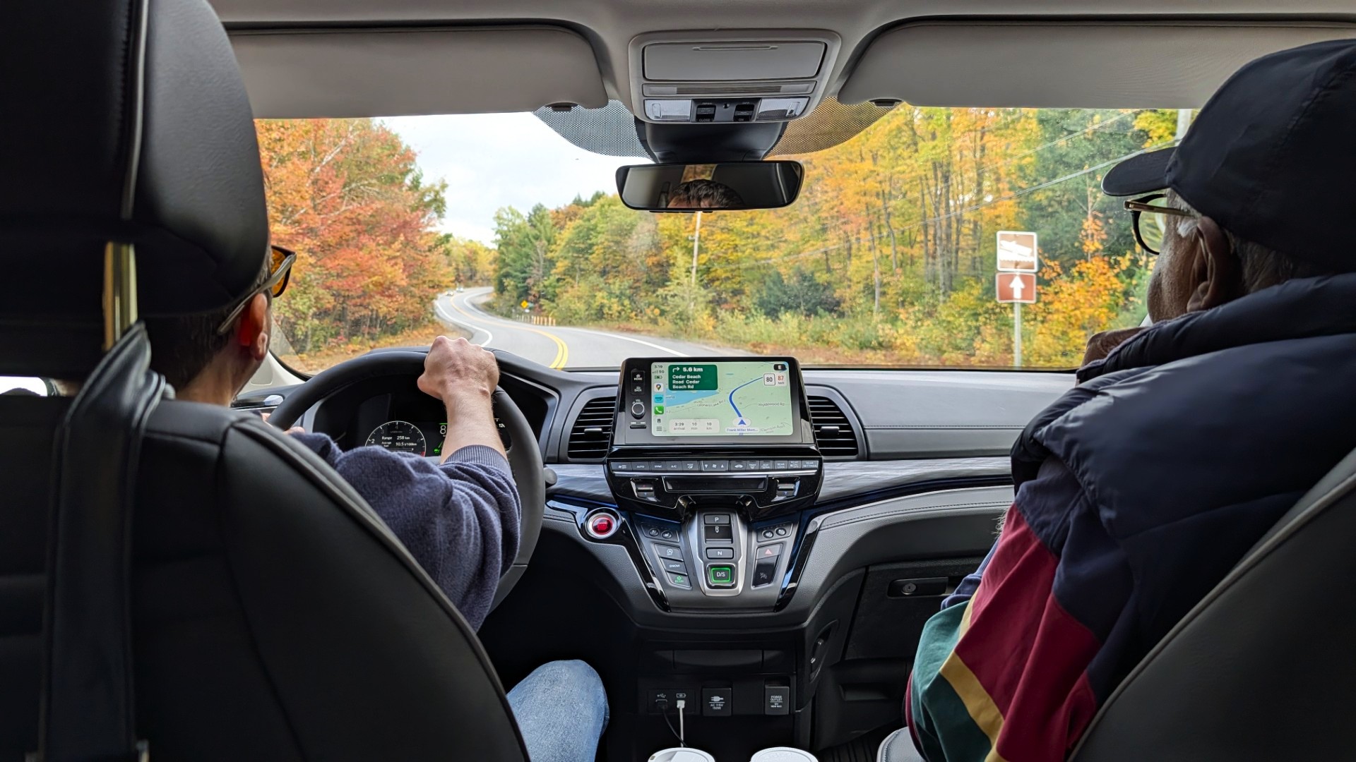 Colourful fall road trip with parents in car