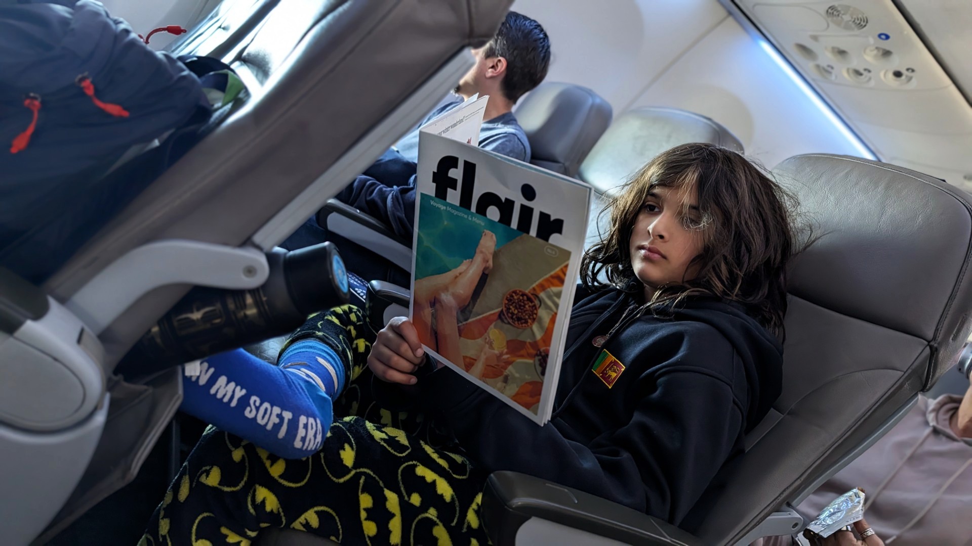 child onboard Flair Airplane reading magazine
